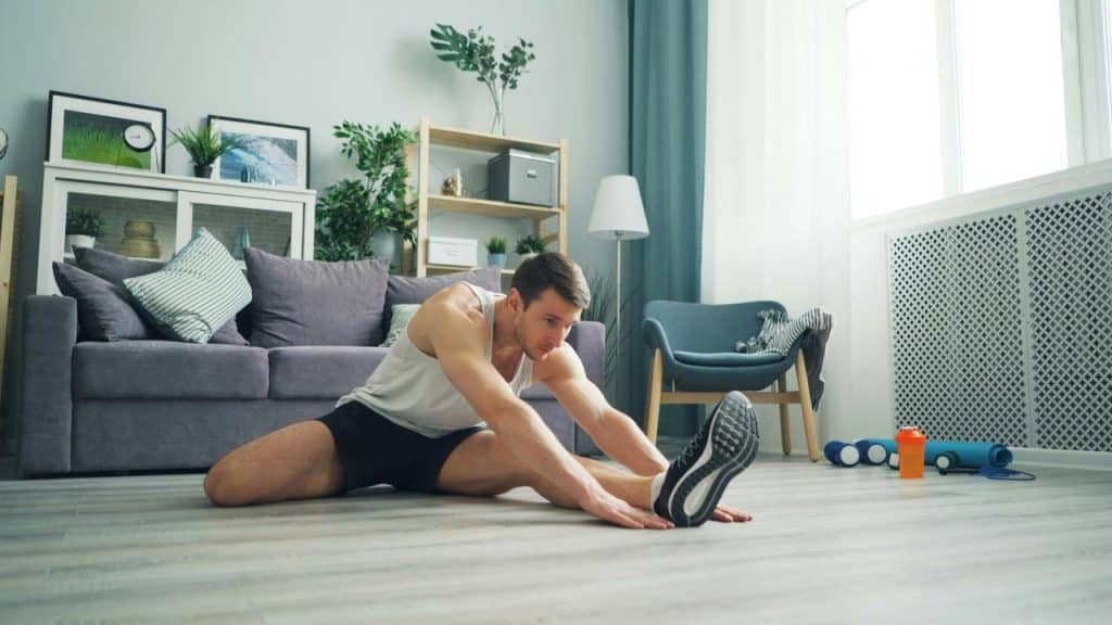 A man stretching on the floor.