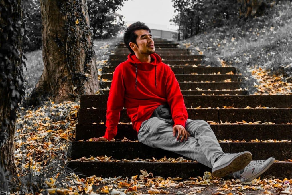 A man sitting at the stairs, just enjoying life.