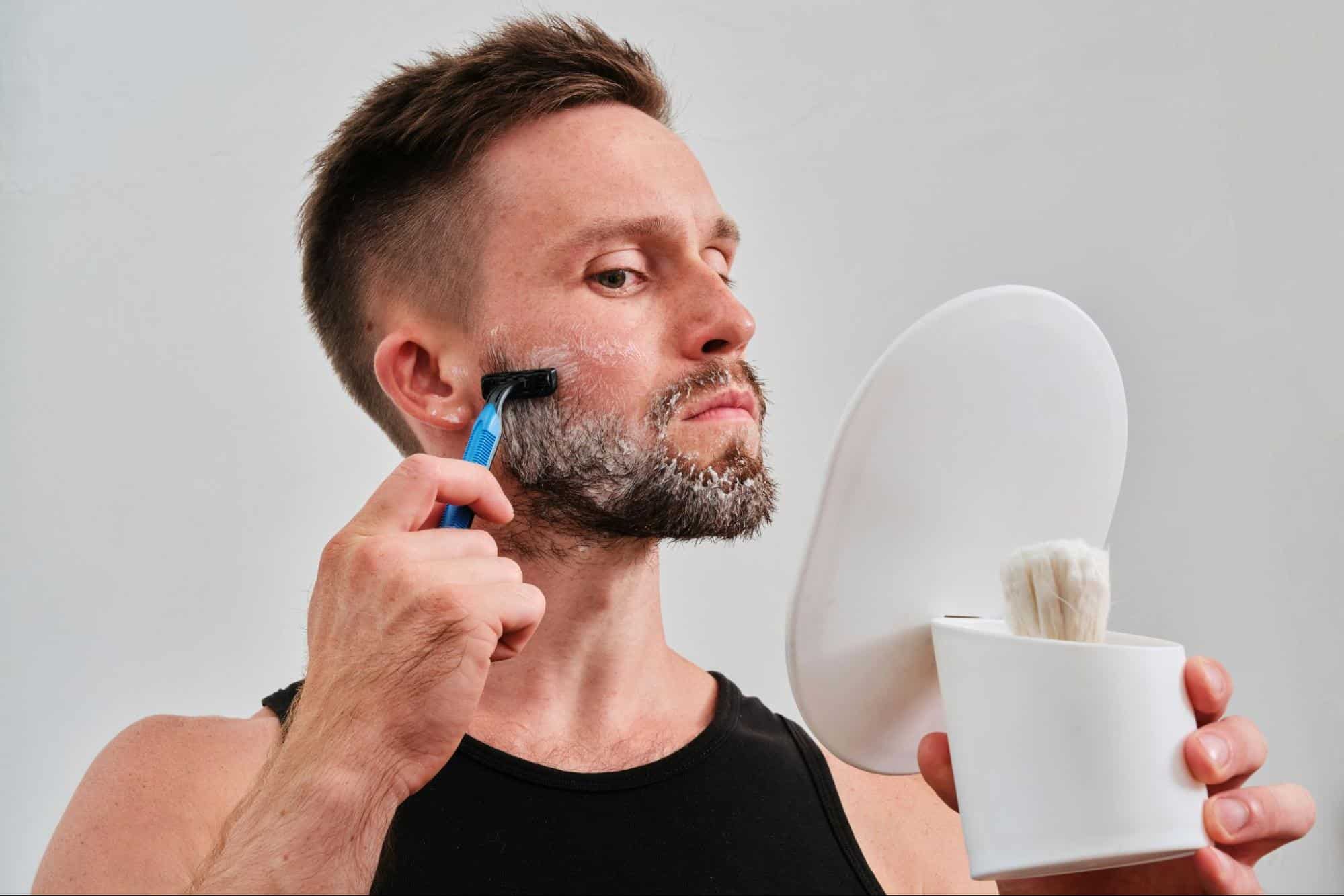 A man trimming his facial hair.