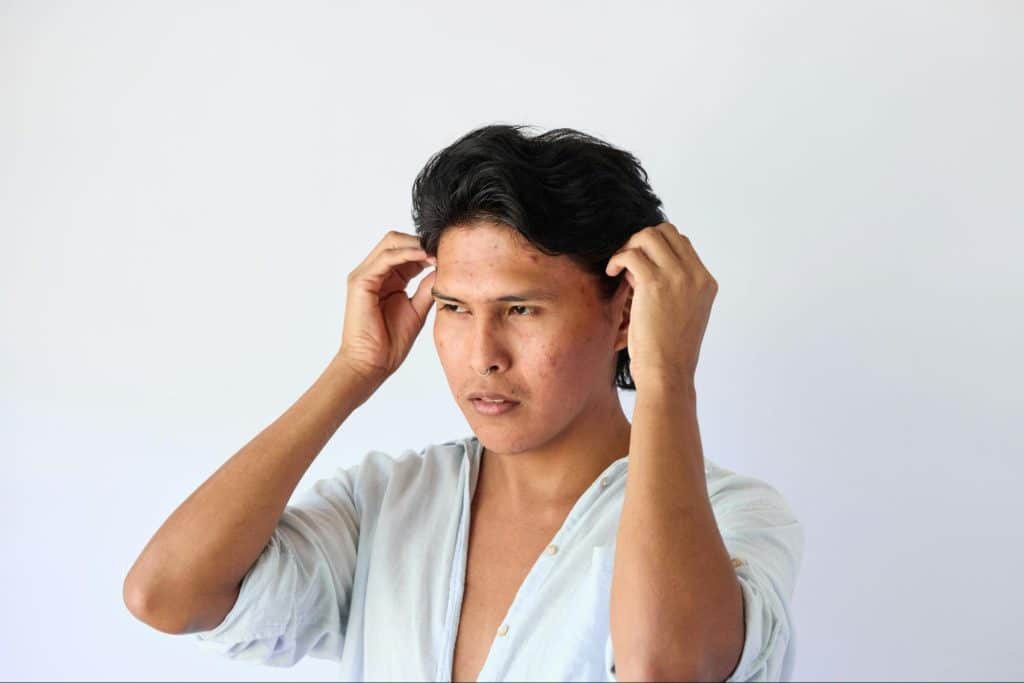 A man cleaning his ears.
