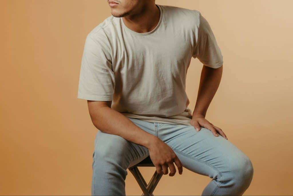 A man sitting at the wooden chair.