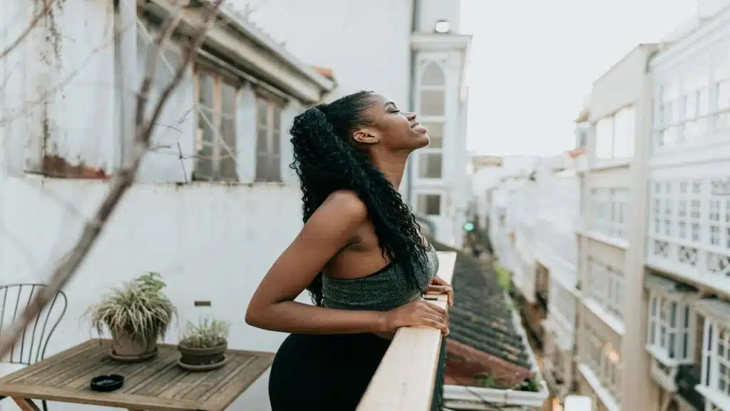 A woman breathes in fresh air