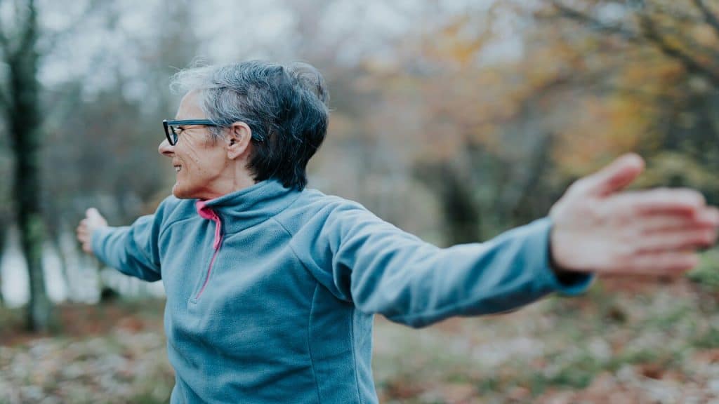 An older woman exercising outdoors