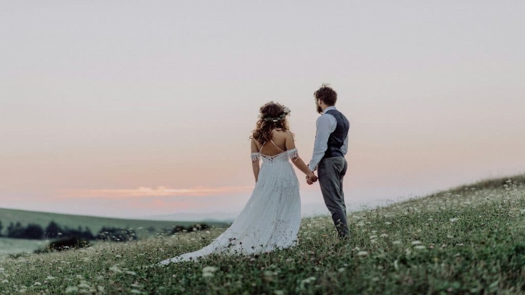 A bride and a groom on a field