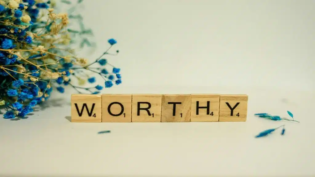 Wooden block letters spelling out “worthy”