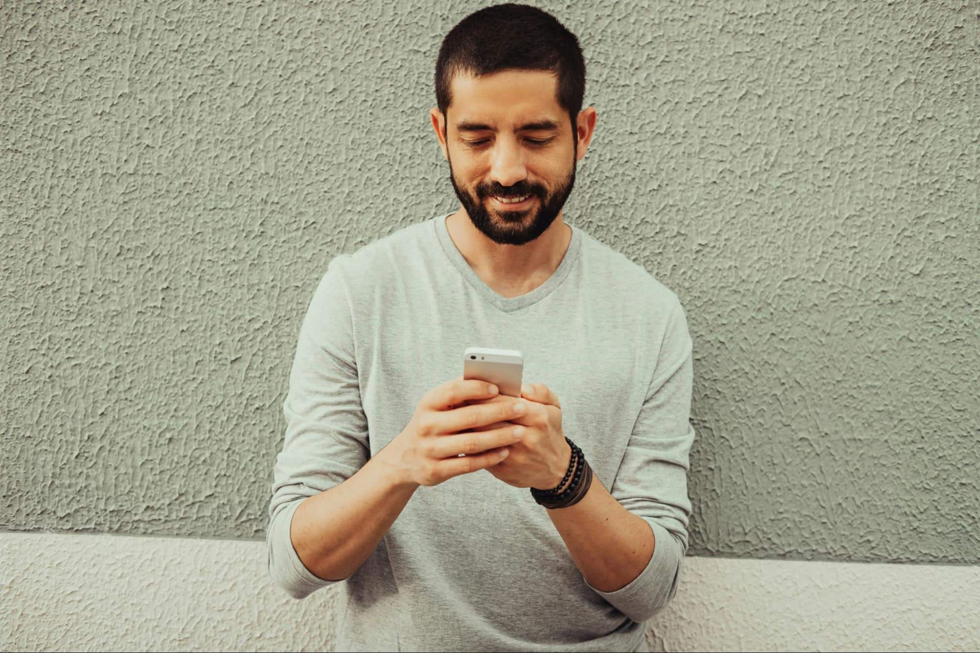 A man texting a woman.