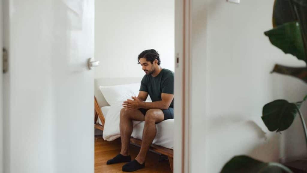 Man taking time to reflect in the room before giving an emotional answer to his partner.