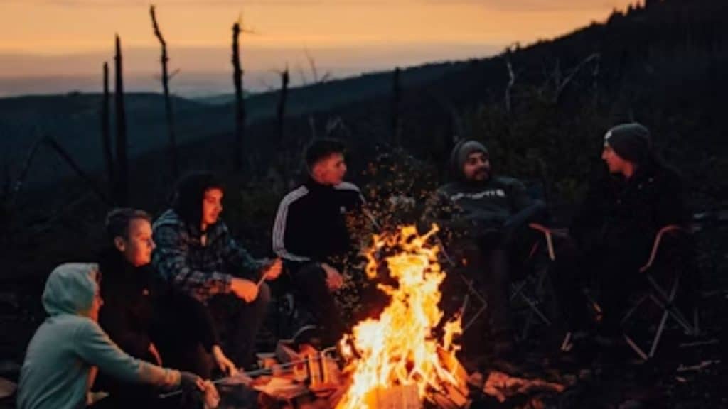 Men around a campfire at a forest retreat