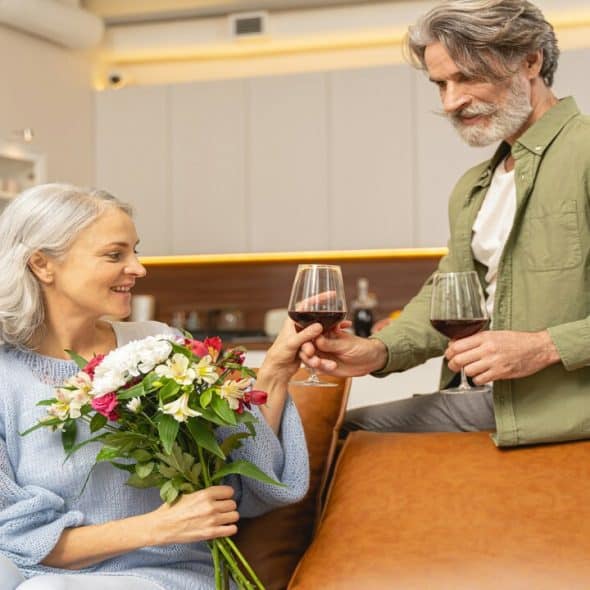 A handsome couple having glasses of wine