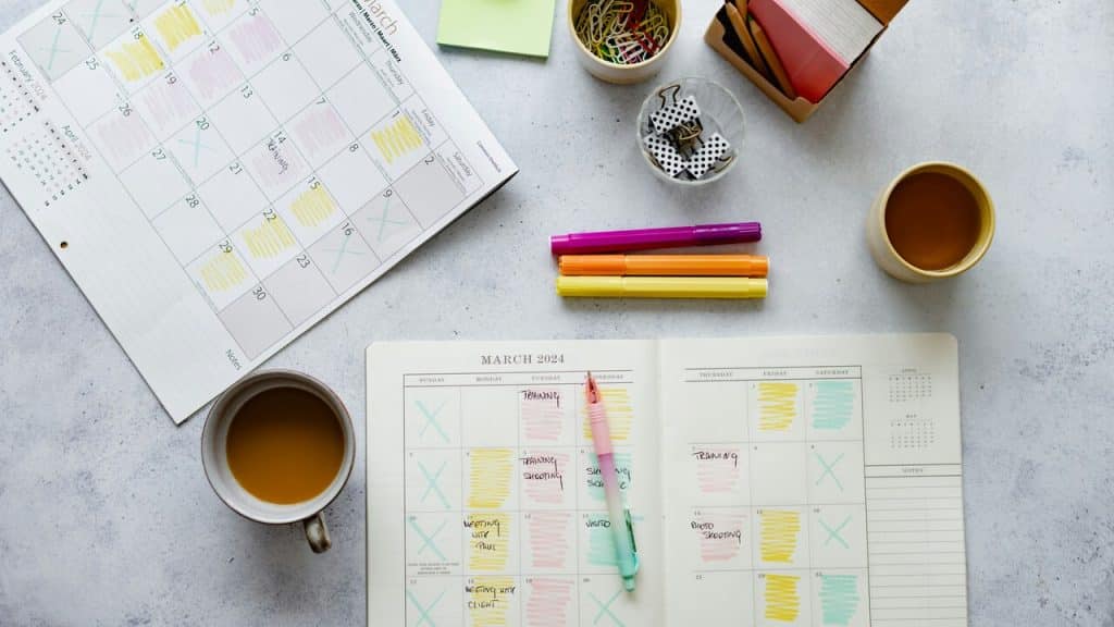 Calendar and cups of coffee laid out on a table