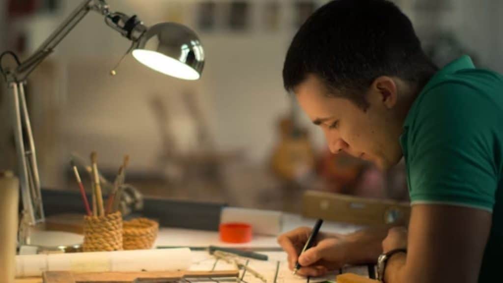 A man planning on a vision board alone in a studio