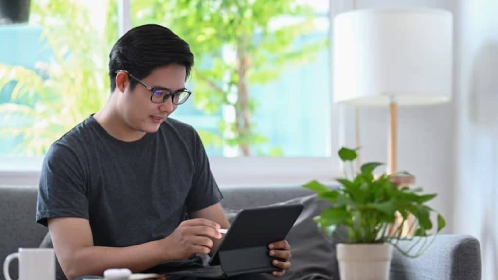 Man tracking food and noting digestive issues on his tablet.