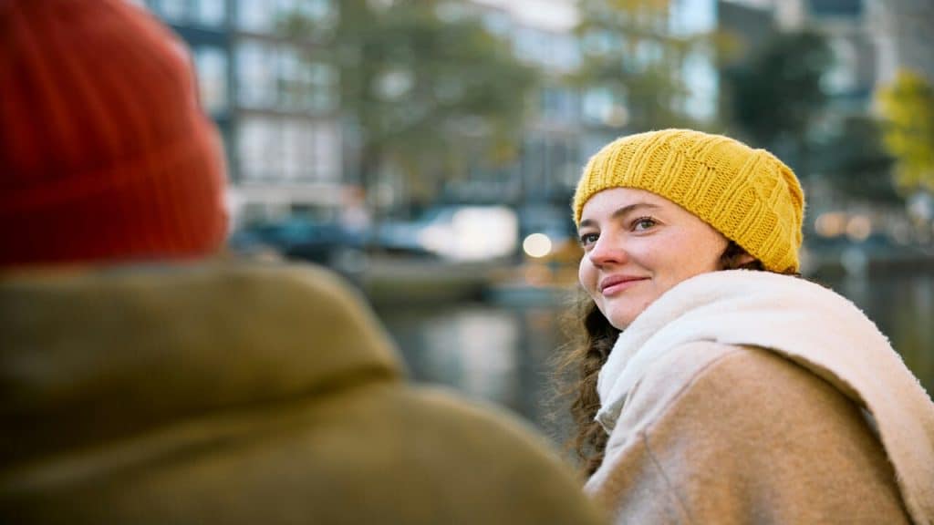 A woman wearing a coat and beanie