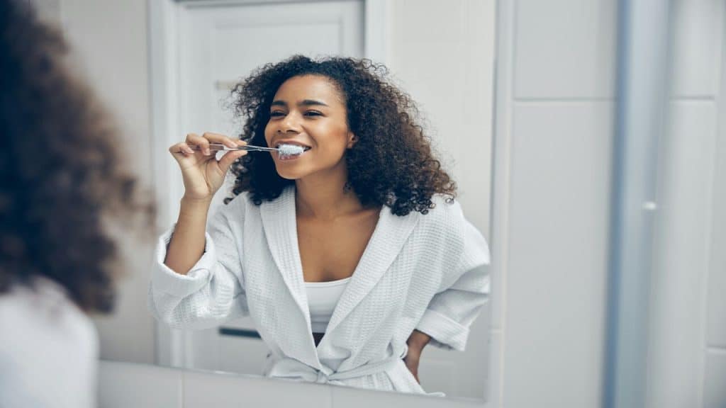 A woman brushing her teeth