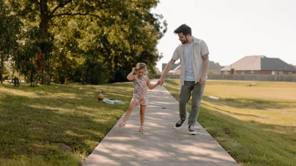  Father enjoying a private bonding moment with his daughter outdoors.