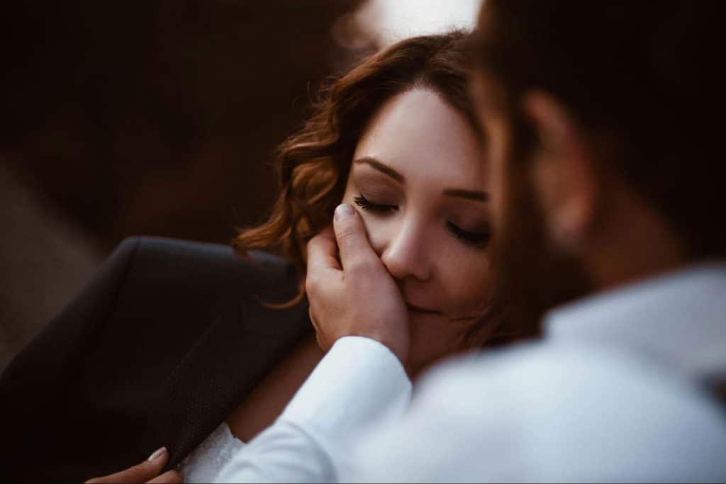 A man caressing a woman’s face.
