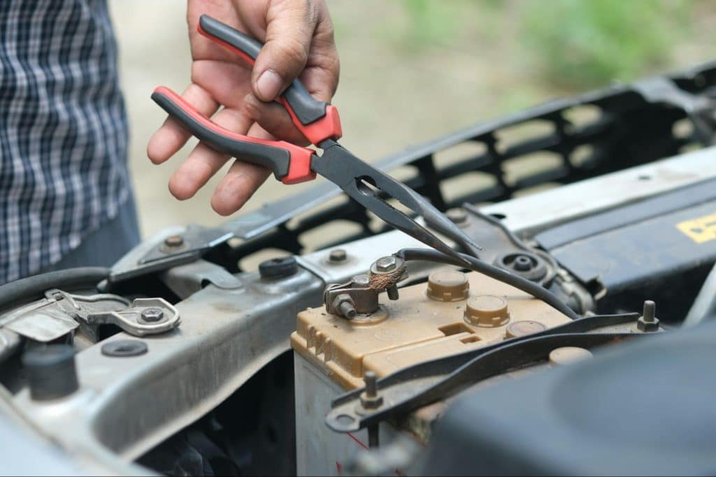 A man fixing something on car.