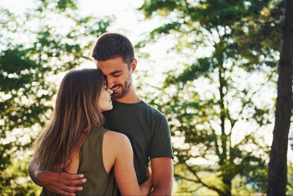 A woman being protected by a man.