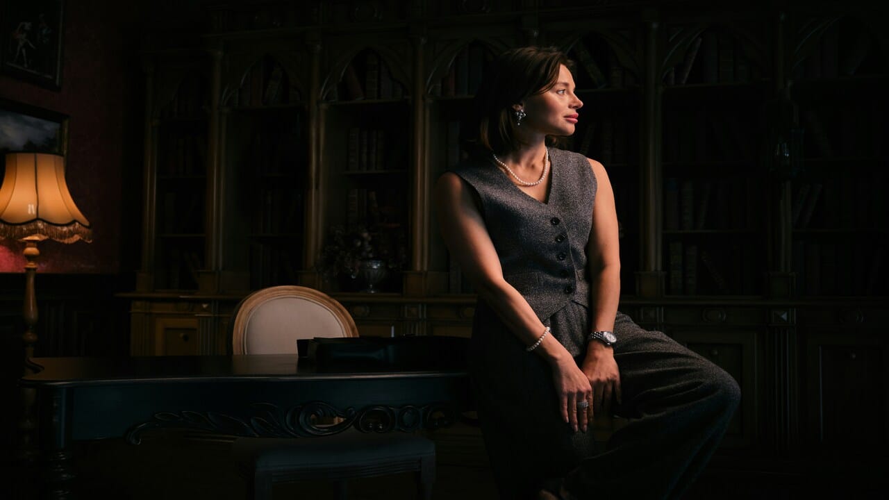 A woman wearing a pearl necklace.
