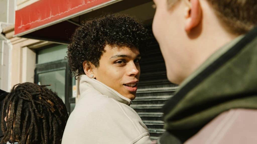 A young man looking back over his shoulder.