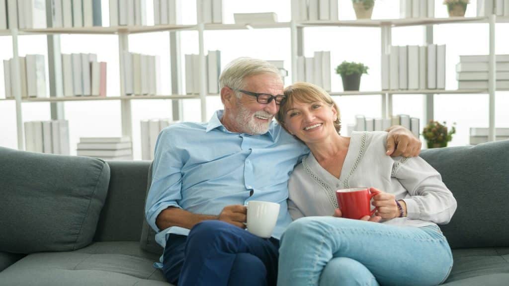 A mature couple having coffee at home
