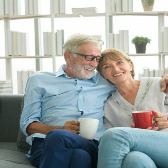 A mature couple having coffee at home