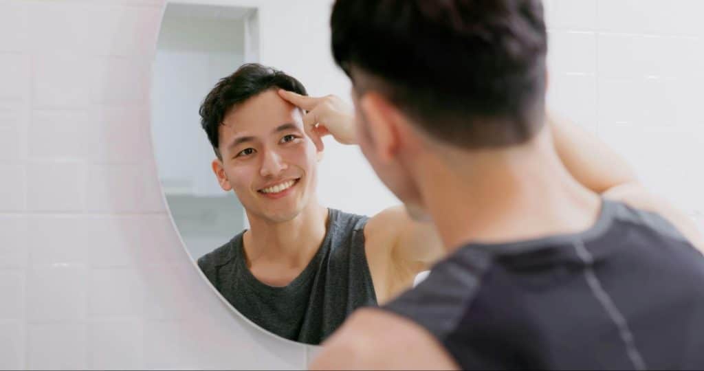 A man looking at the mirror 