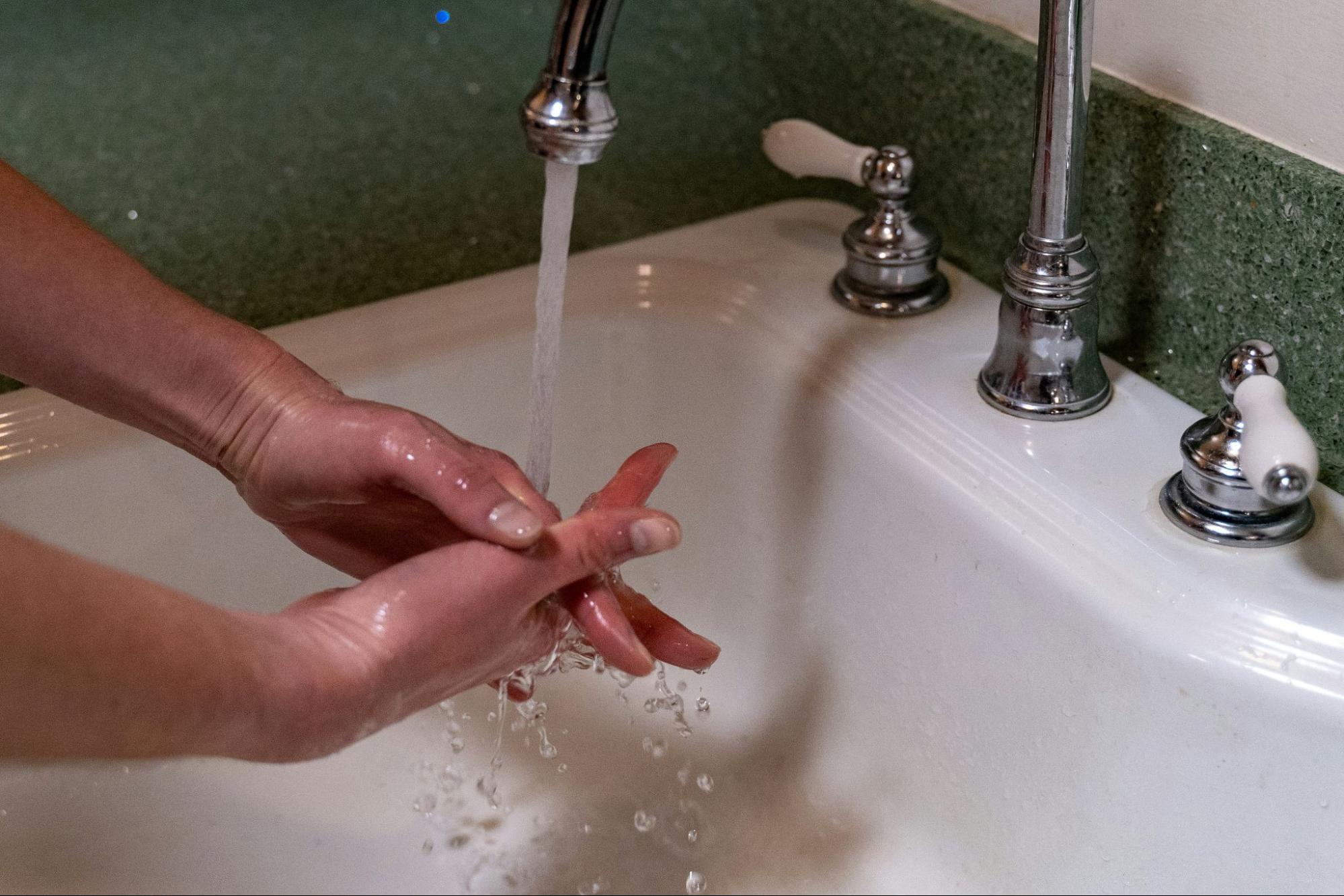 A man washing his hand.