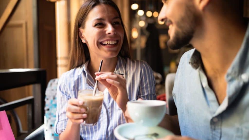 Woman maintaining eye contact with a man, suggesting interest without speaking