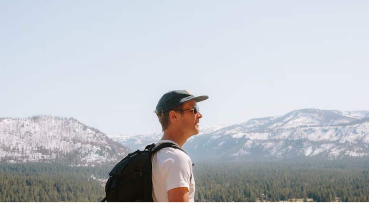 A man enjoying a peaceful solo hike with a relaxed expression.