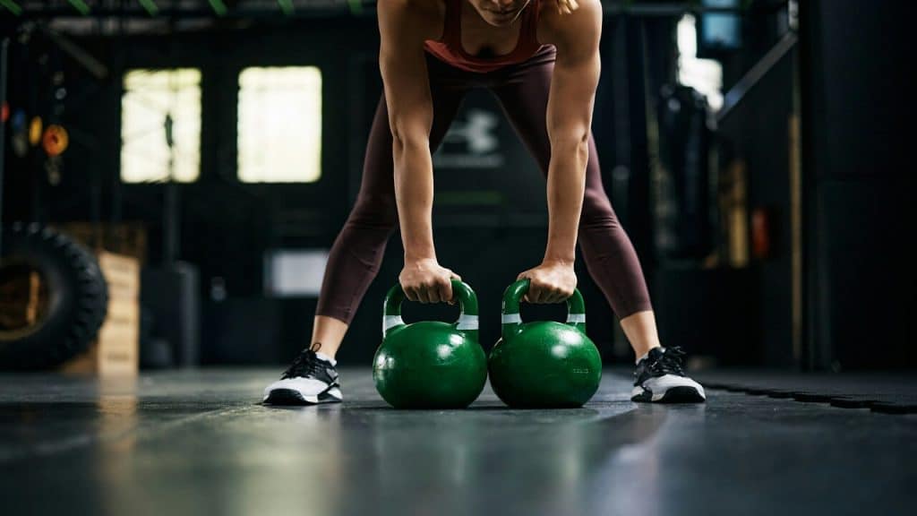 A woman using kettlebells for working out