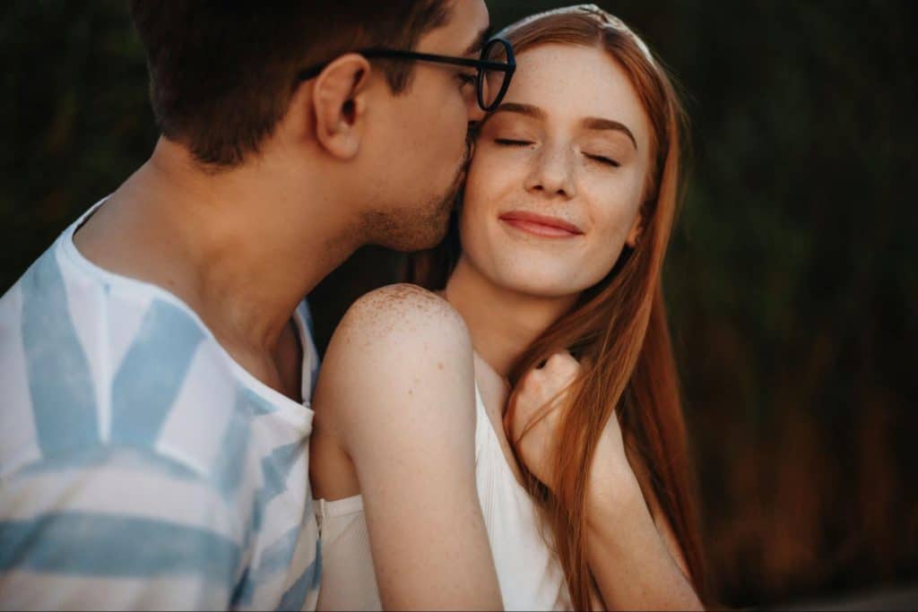 A man kissing a woman’s cheek