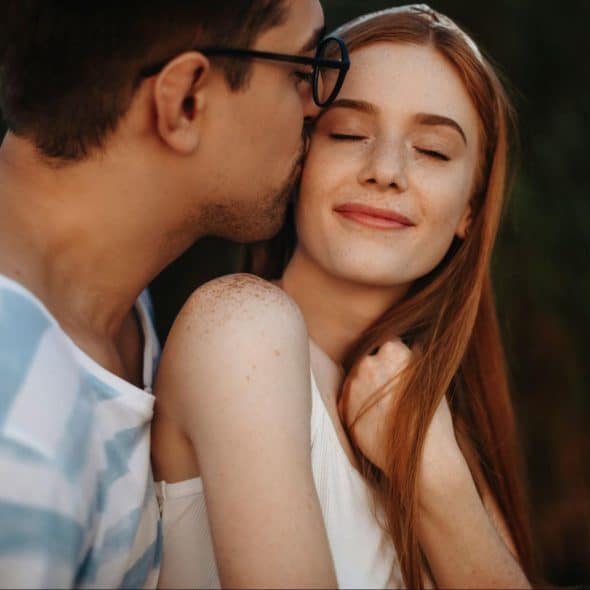 A man kissing a woman’s cheek