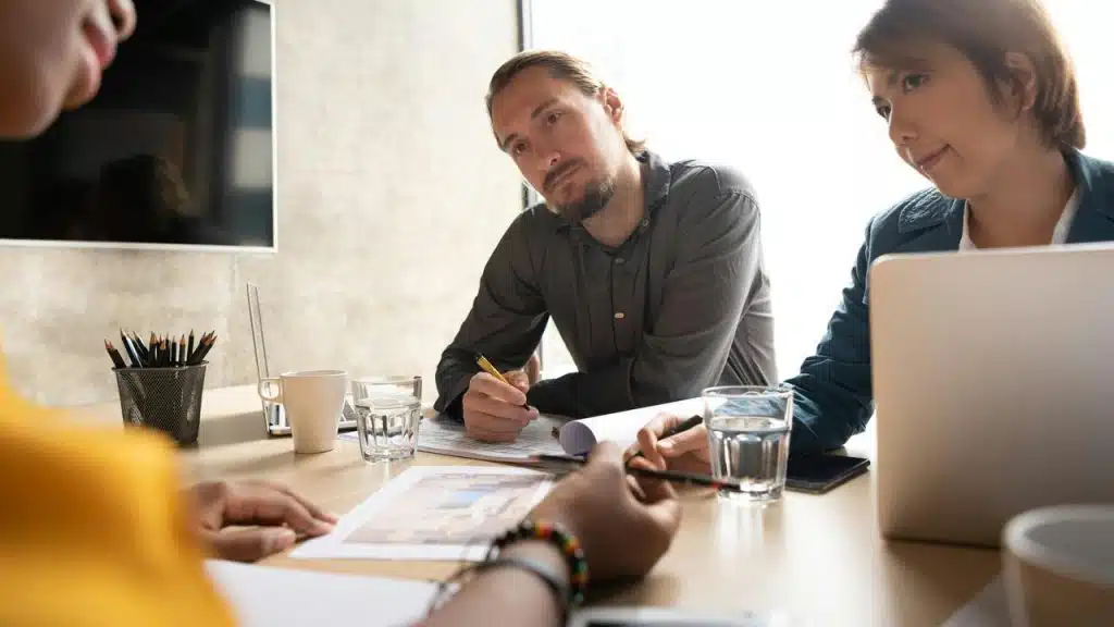 A group of colleagues reviewing documents at a table.