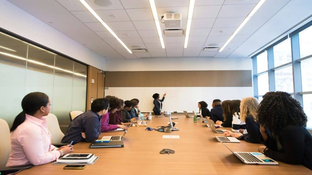A woman presenting at a conference room
