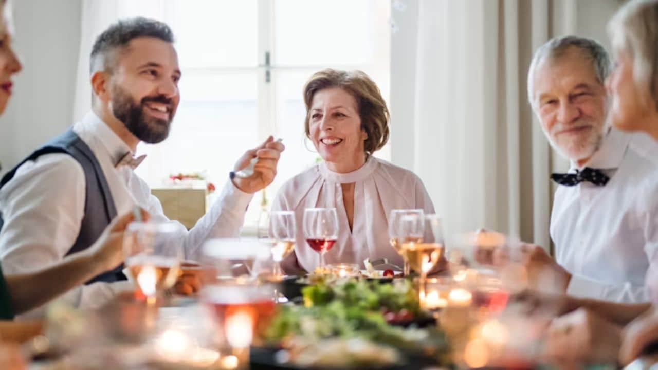 A man sharing a meal with his parents in a cozy dining room.