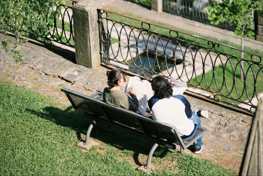 A man and woman sitting at the bench