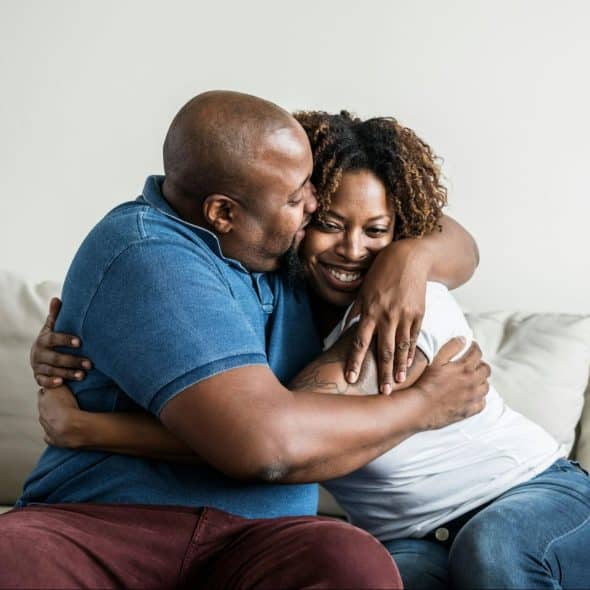 A husband hugging his wife.