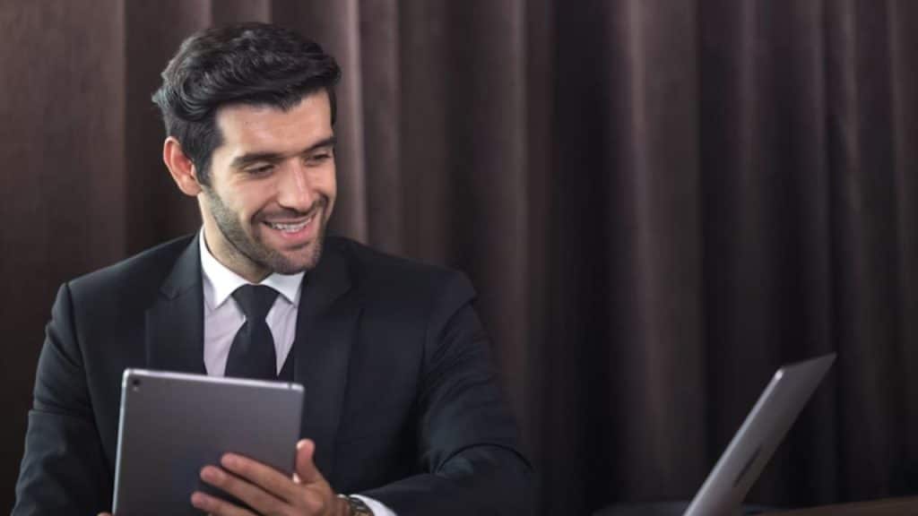 Middle aged man smiling in recognition while reading humorous content