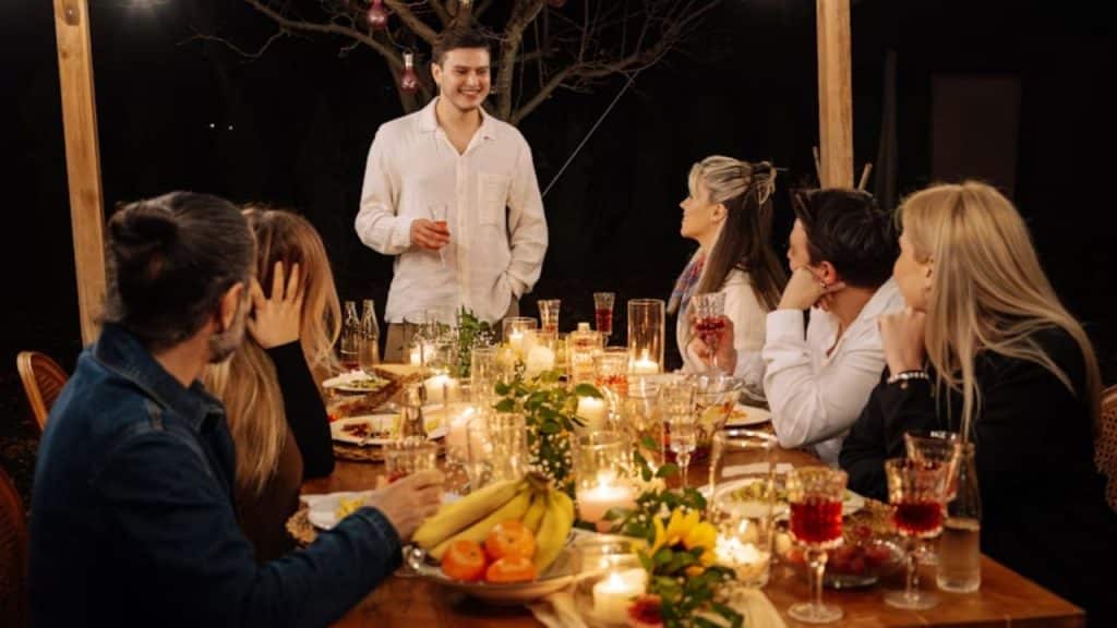 Man talking in a group and pretending that everything’s fine