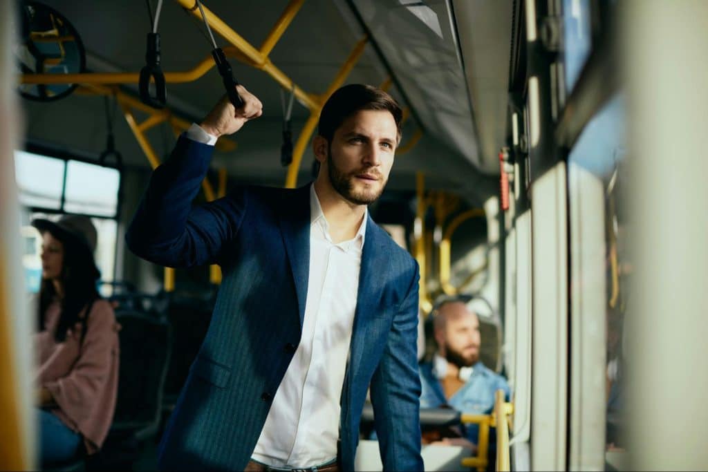 A business man at a public vehicle.