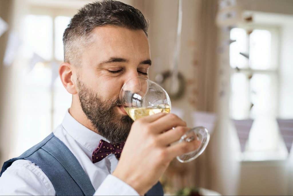 A man drinking an alcoholic beverage.