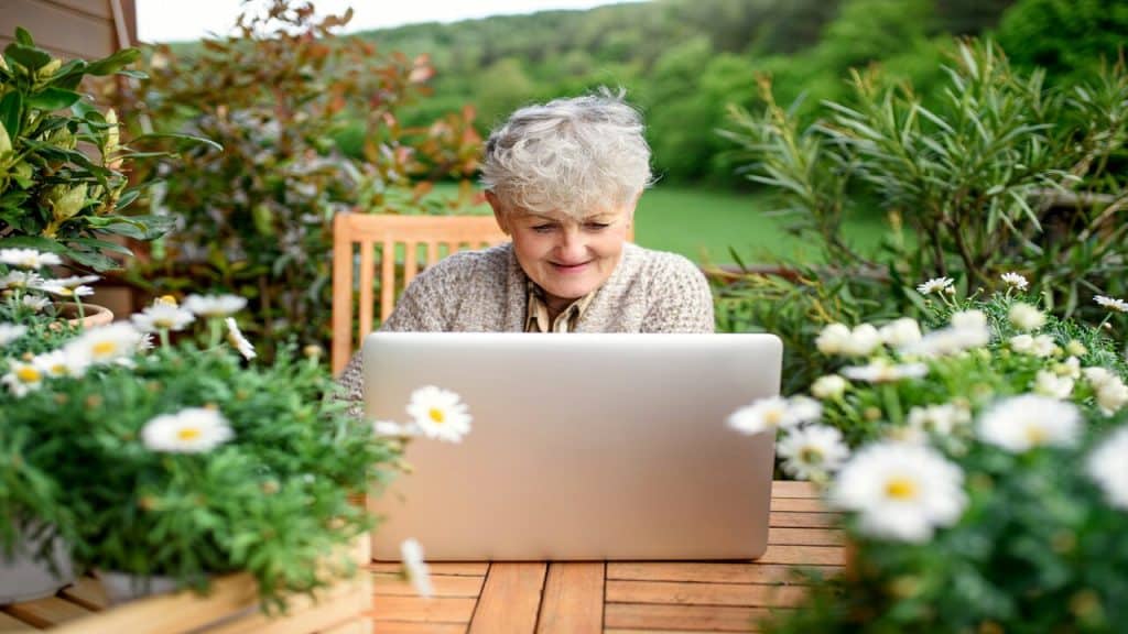 An older woman using her laptop