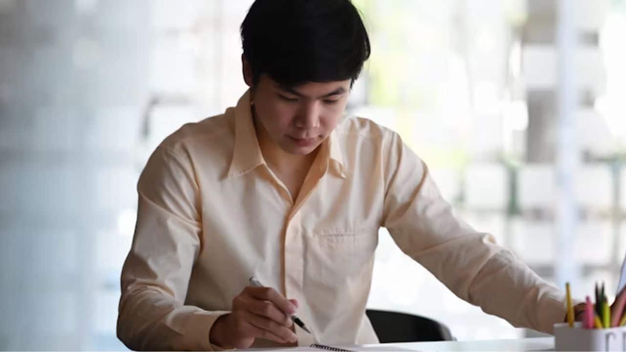 A man journaling, reflecting on past dating behavior to foster personal change