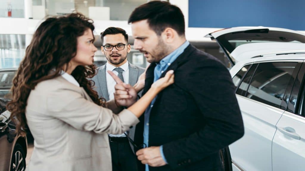 A couple fighting at a showroom