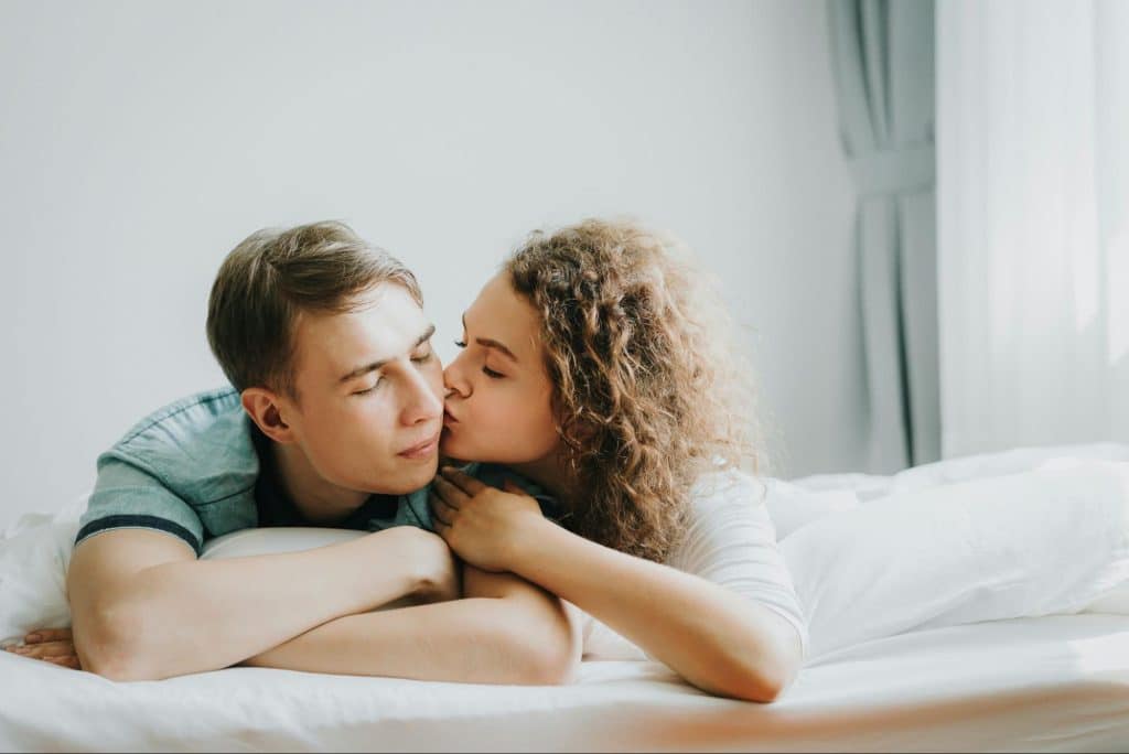 A woman kissing a man 