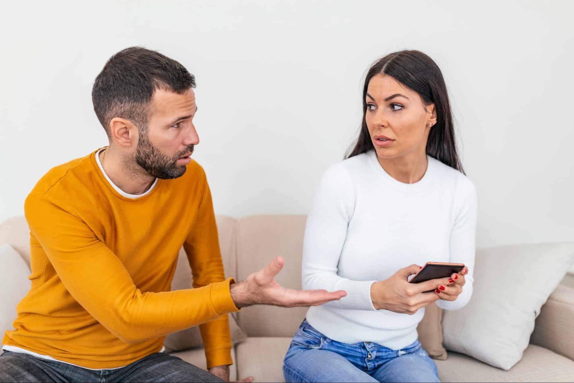 A man getting the phone from his girlfriend.