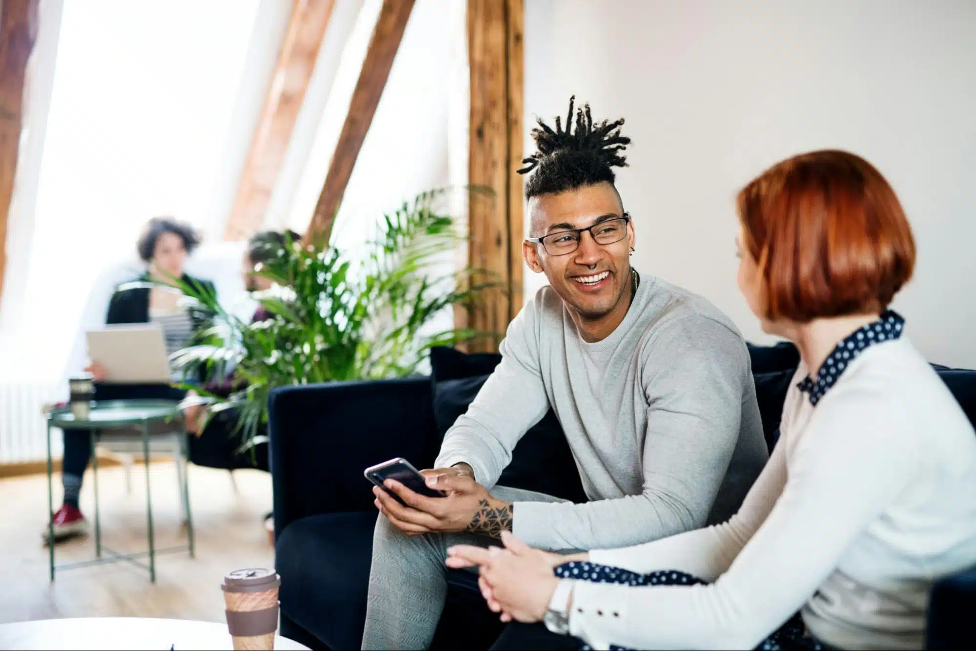 A man and woman talking while at the living room.