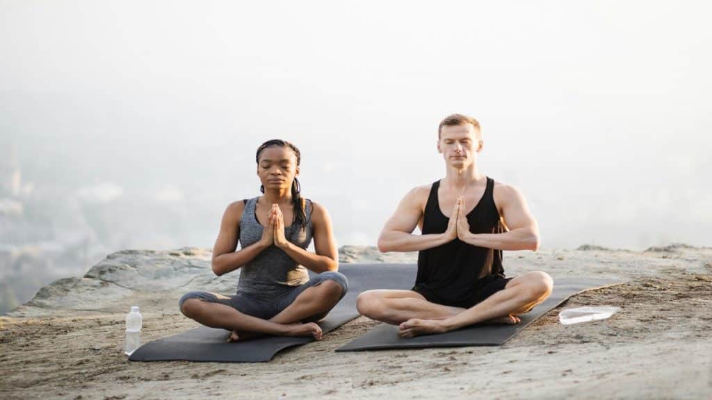A couple doing yoga together 