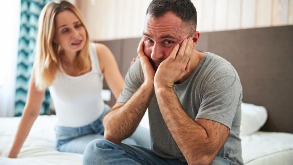 Man looking emotionally weighed down during a partner’s intense discussion.